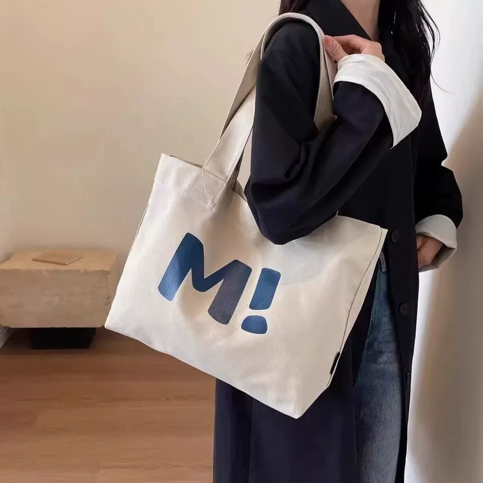 Canvas shopping tote being used for grocery shopping
