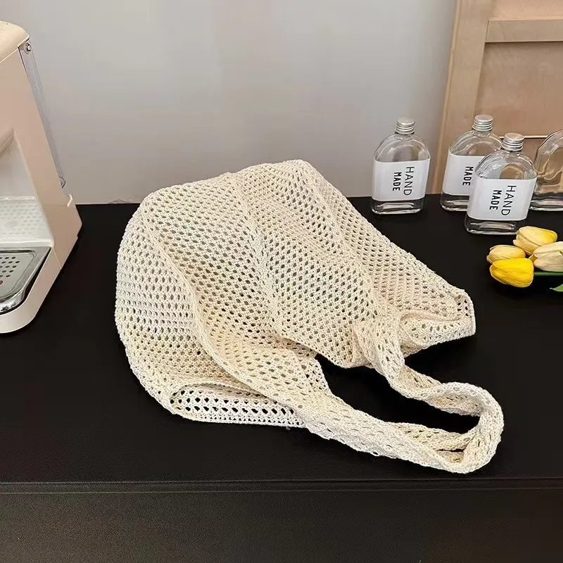 Crocheted mesh tote bag at beach with summer outfit