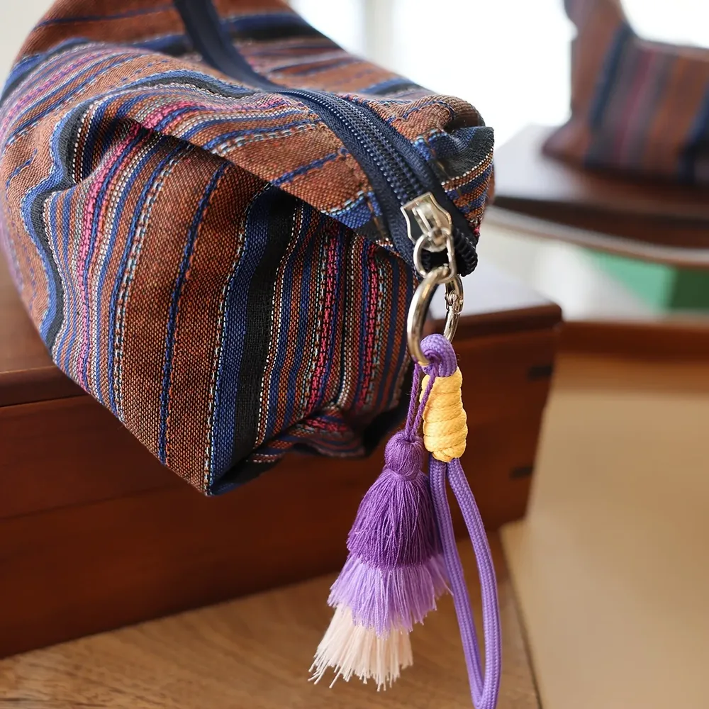 Ethnic-stripe cosmetic pouch in brown, blue, black and pink bands