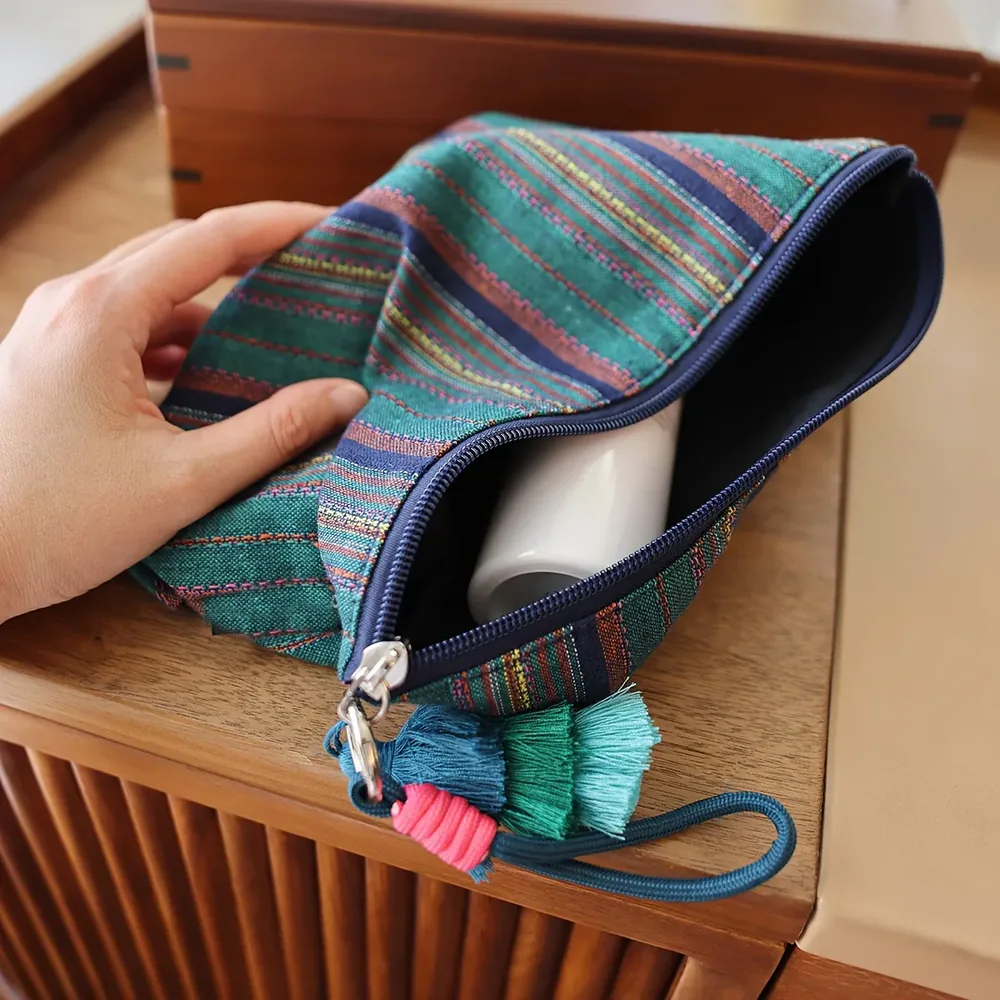 Striped boho pouch showing metal ring and knotted fringe pull