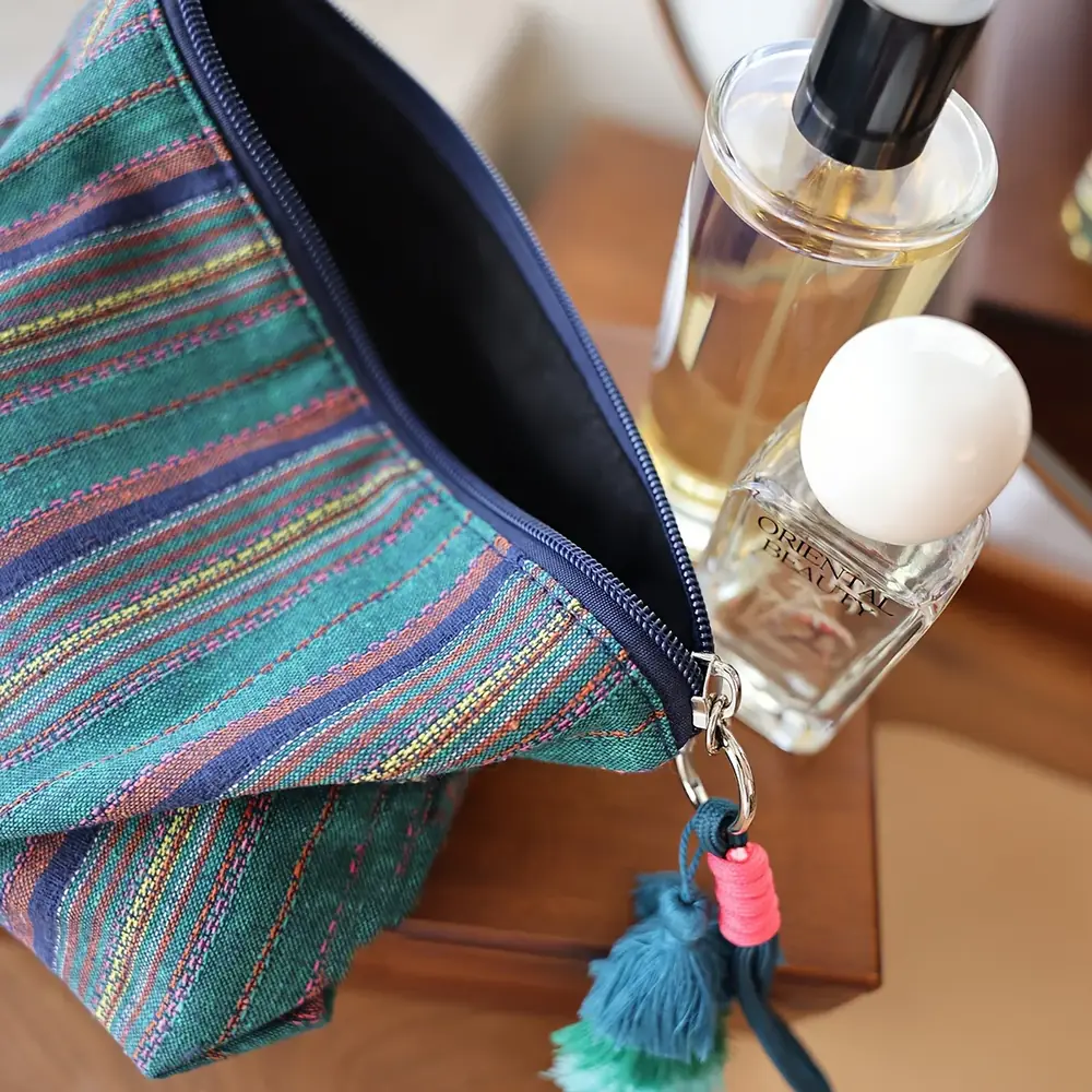 Boho fringe cosmetic pouch styled as a hand-held accessory