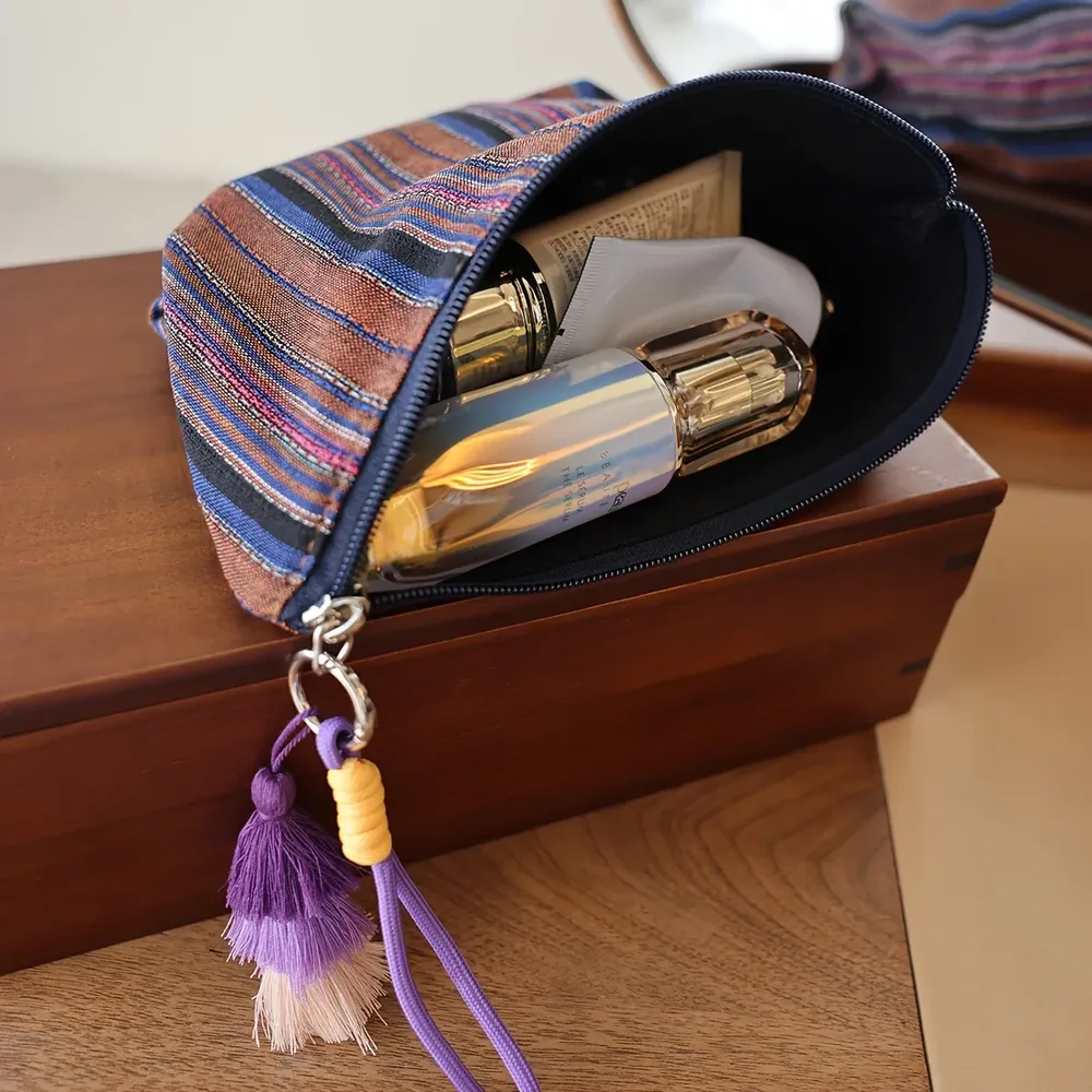 Woven stripe pouch with tassel decoration, zip closure