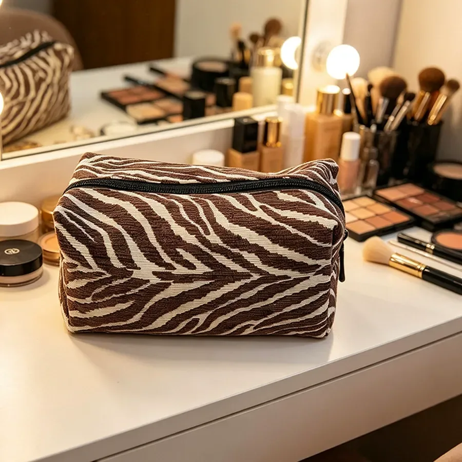 Zebra-pattern chenille pouch showing zipper and plush fabric