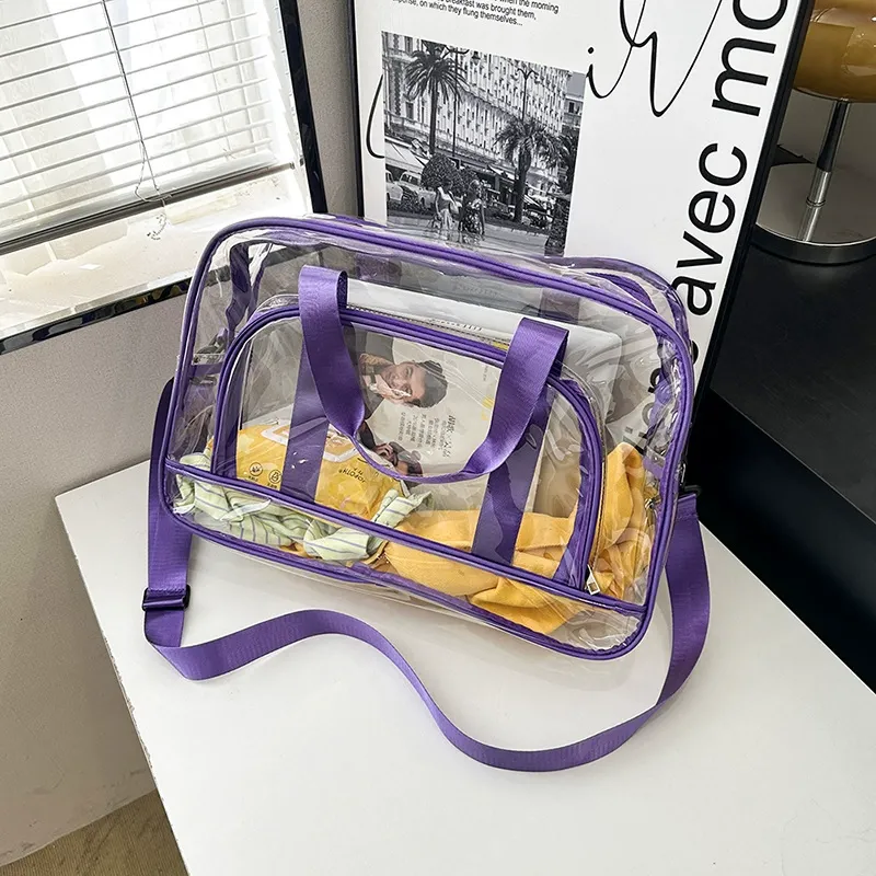 Clear PVC travel bag with purple edge binding on table