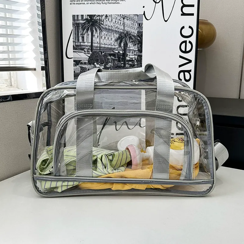 Clear PVC duffel showing contents through the shell with grey binding trim