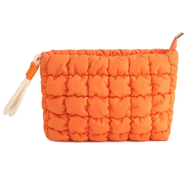 Puffy quilted cosmetic bag with braided rope accent and knot detail