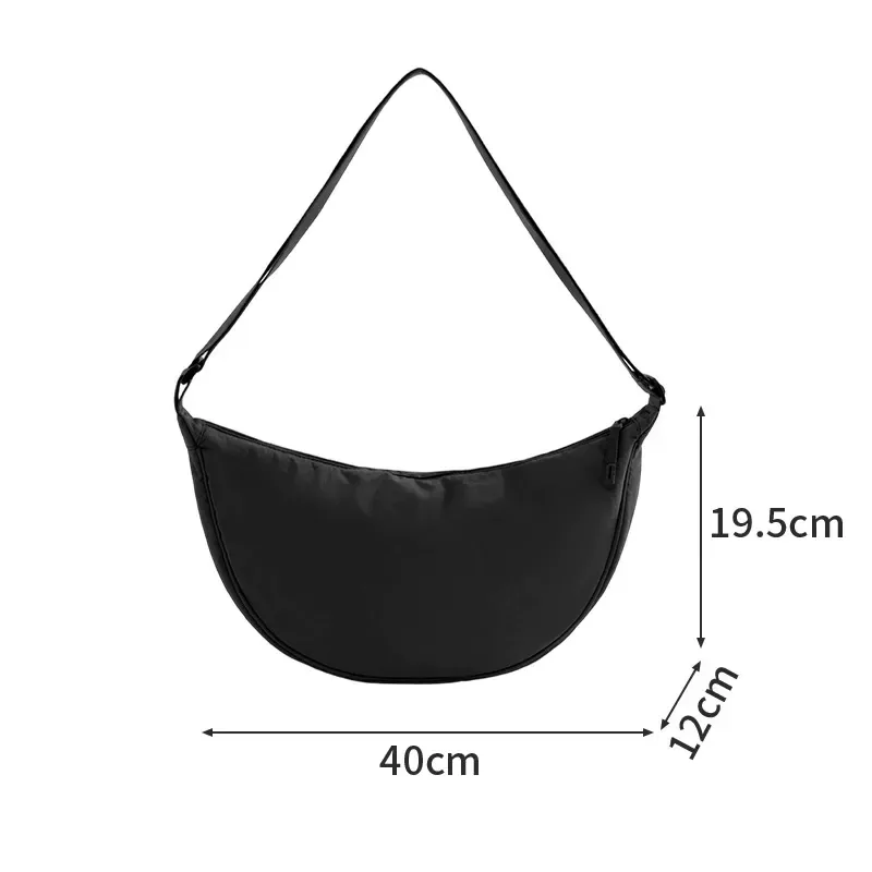 Crescent crossbody bag showing side zipper and strap hardware