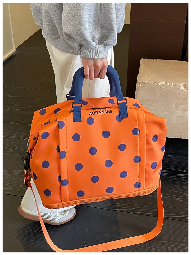 Polka dot duffel in orange with deep purple dots color option