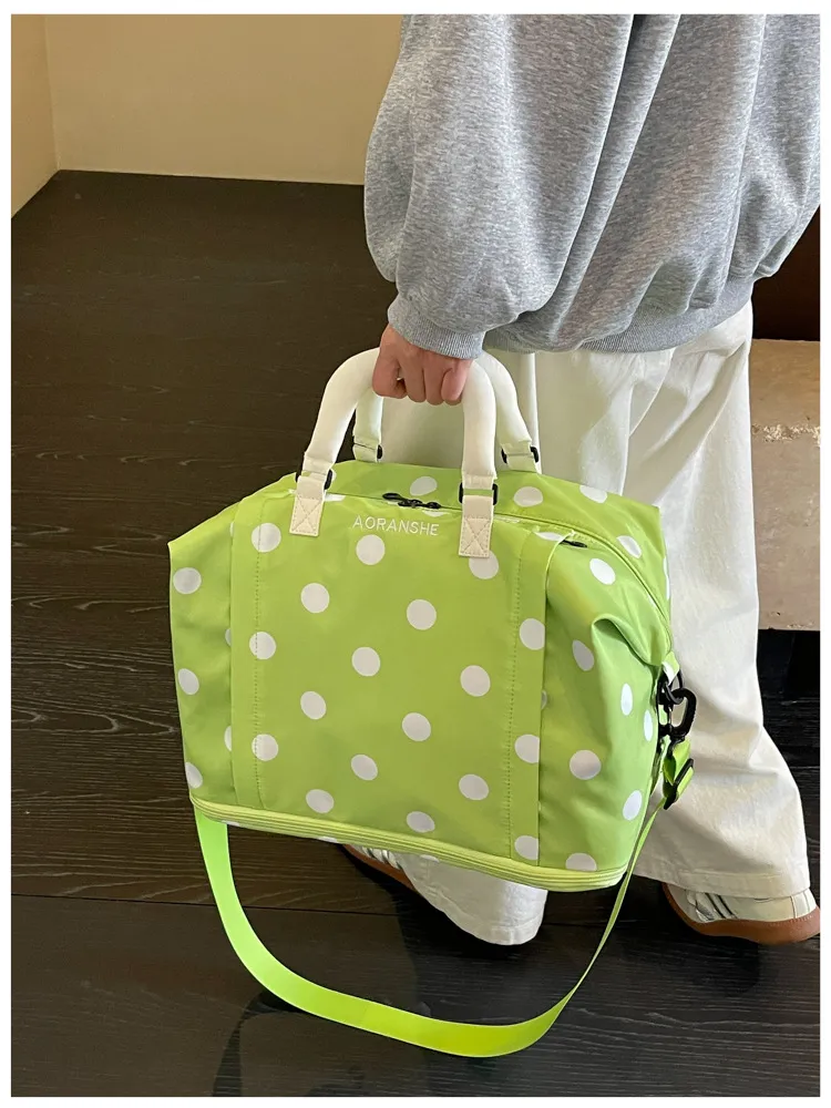 Dark grey duffel with white polka dot pattern and matching handle