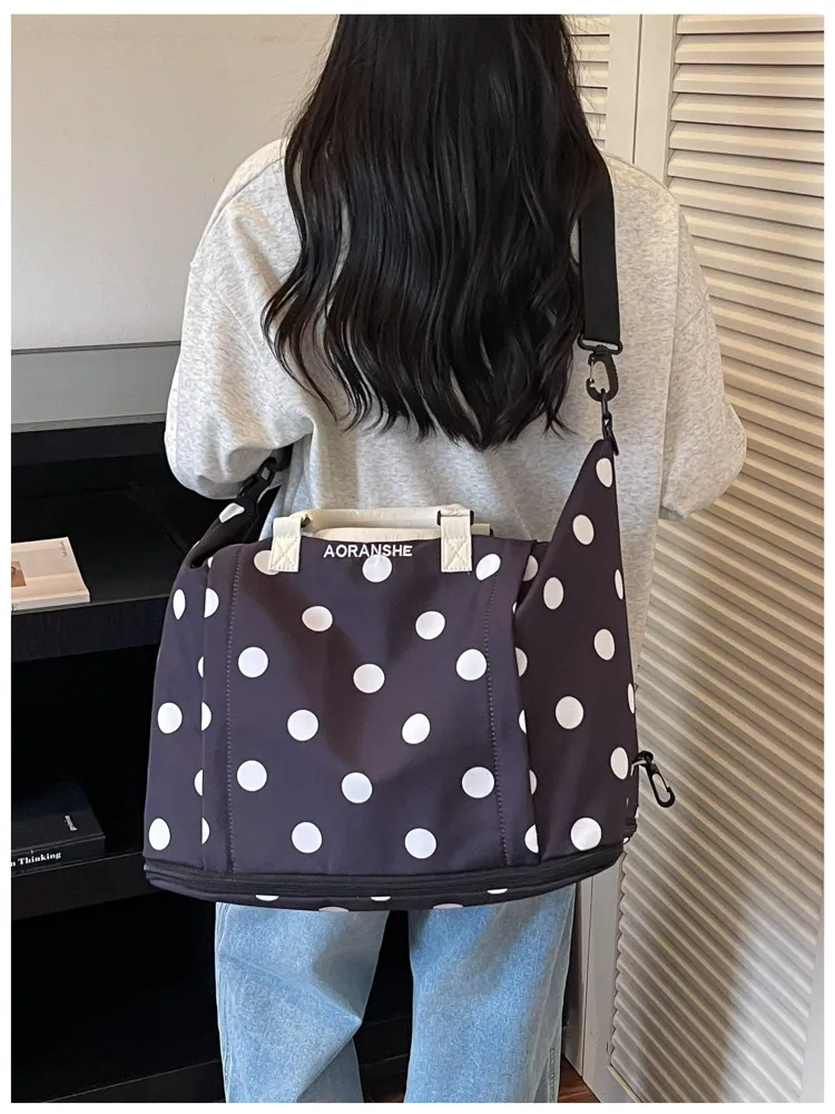 Polka dot travel duffel in blue and light purple color ways