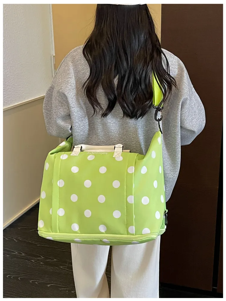 Polka dot duffel showing oxford fabric texture and zipper