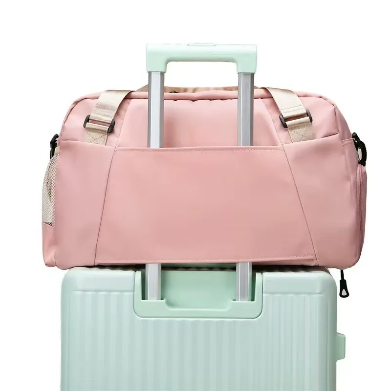 Gym duffel bag hooked on luggage trolley for travel