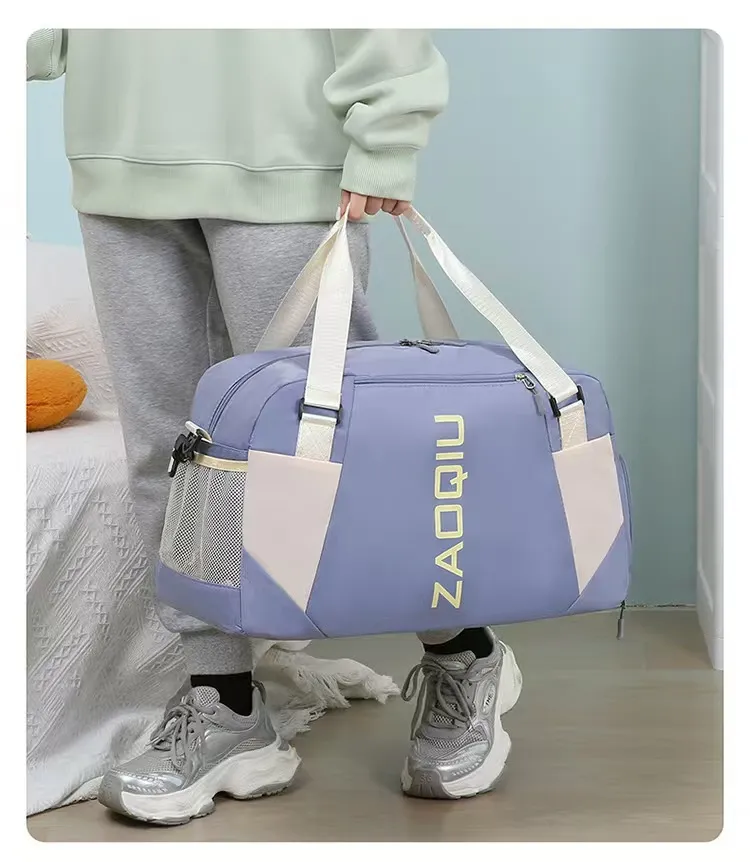 Person carrying light purple gym duffel bag by hand