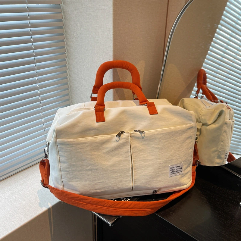 Expandable black Oxford travel duffel bag.