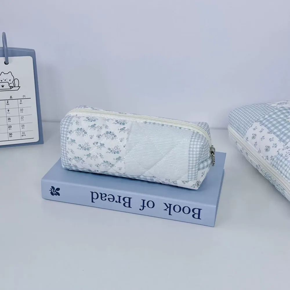 Patchwork cosmetic bag showing mixed floral and gingham fabric panels