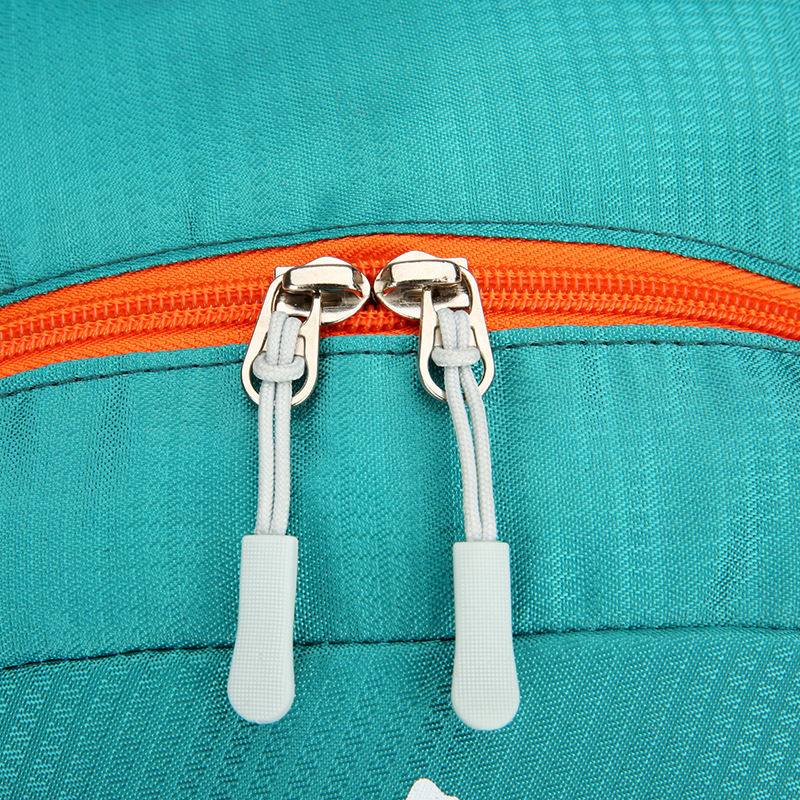 Side view showing compression straps, grab handle, and USB charging port.