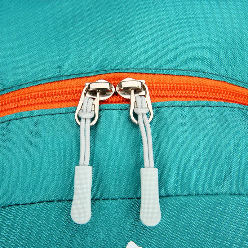 Side view showing compression straps, grab handle, and USB charging port.