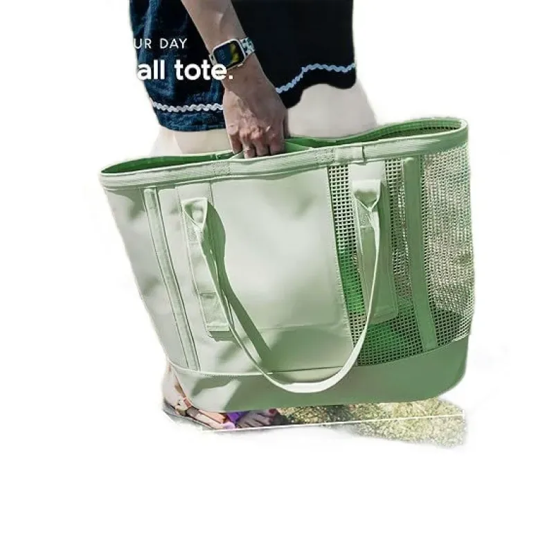 Mint green mesh student commuter tote held by hand, canvas and mesh panels