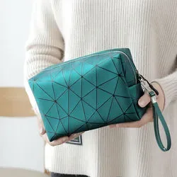 Hand placing a bottle into the open quilted PU cosmetic bag