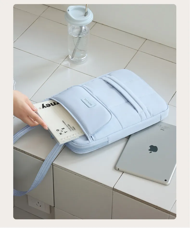 Taking tablet out of pastel shoulder laptop bag