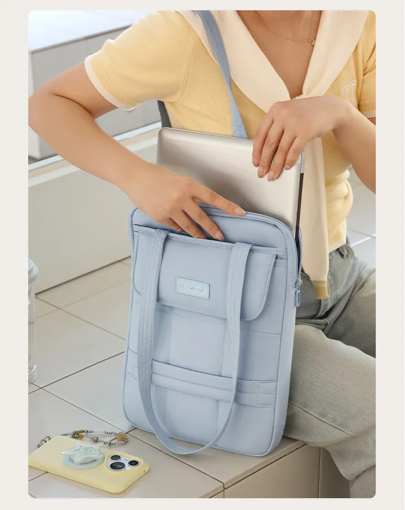 Putting laptop into pastel shoulder bag, commuter use