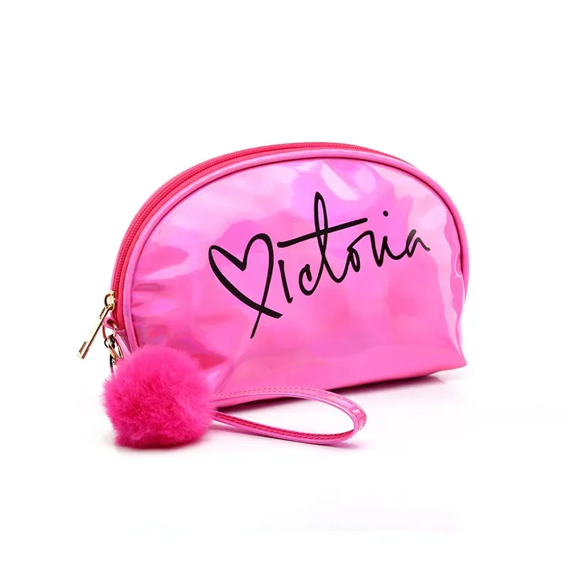 Laser half-moon bag showing print and pom-pom charm detail