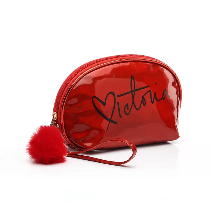 Half-moon shaped cosmetic bag with pom-pom decoration