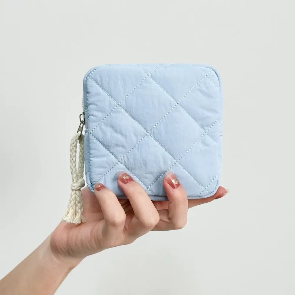 Quilted cosmetic pouch with drawcord and embroidered bow