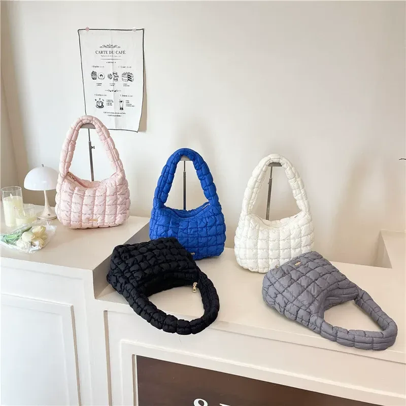 Quilted underarm bag showing puff quilting and metal label