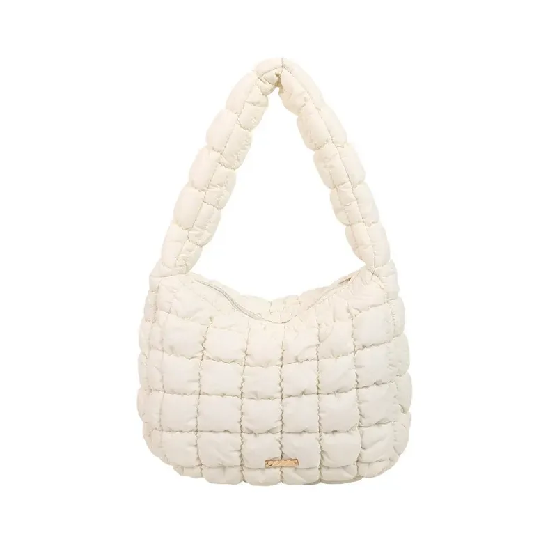Cream quilted cloud underarm bag with crescent silhouette on white background
