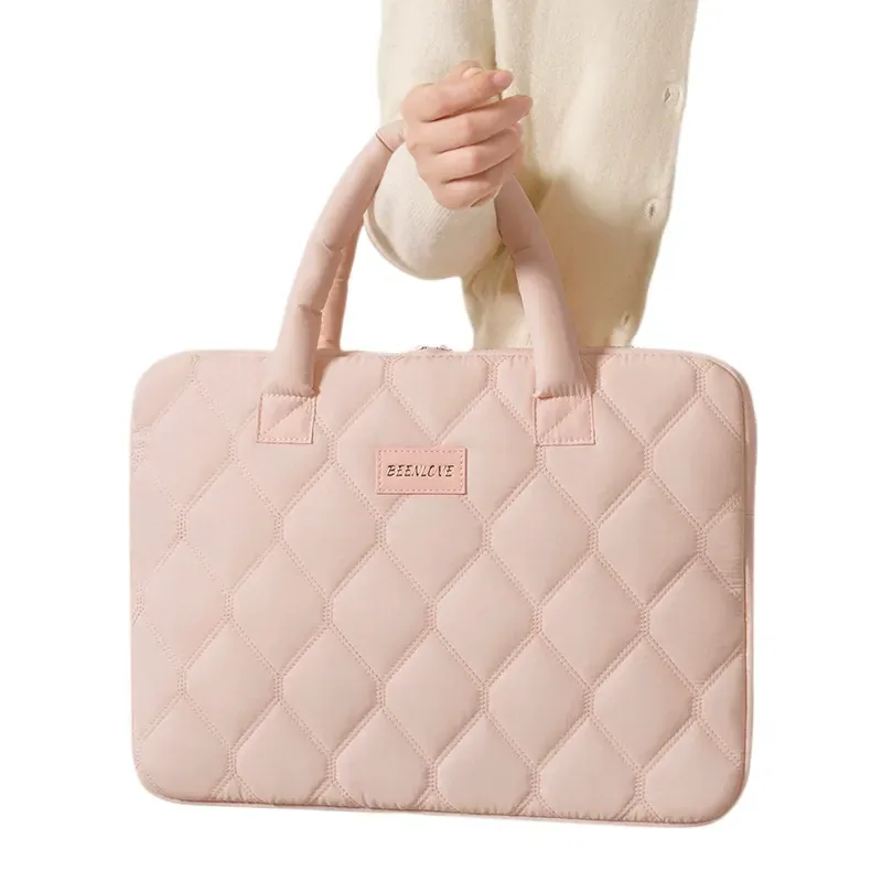 Quilted laptop sleeve showing diamond stitching and open laptop compartment