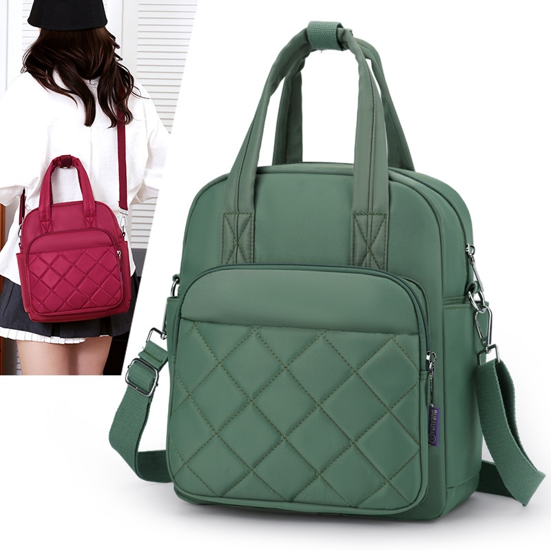 Green color variant of quilted nylon convertible backpack with model wearing burgundy version
