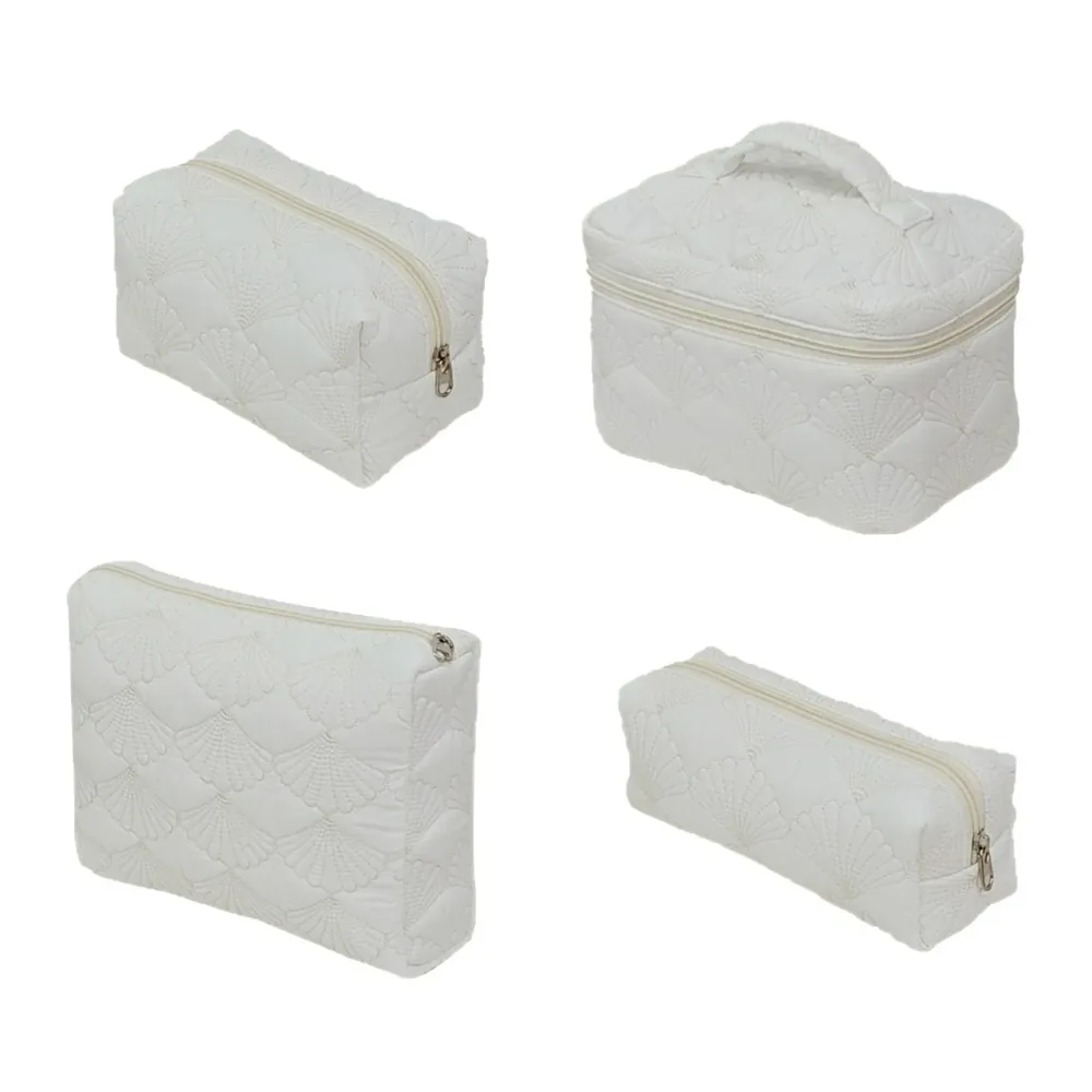 Four white quilted shell-pattern cosmetic bags in different styles