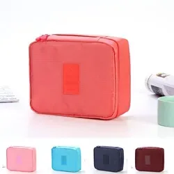 Travel underwear organizer pouch carried by its hand strap