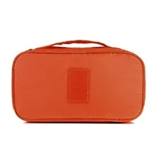 Orange fabric underwear travel organizer pouch with label area and hand strap