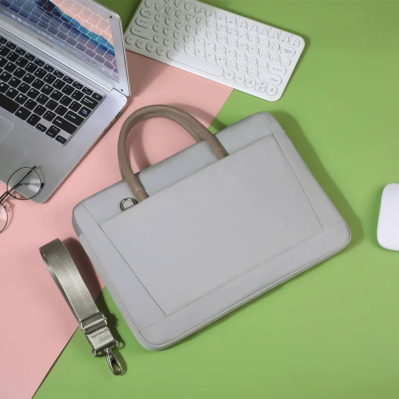 Close-up of premium metal hardware, zipper puller, and stitching detail on laptop bag