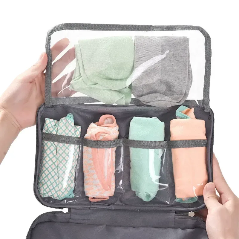 Grey waterproof lingerie travel organizer with clear top flap and four compartments