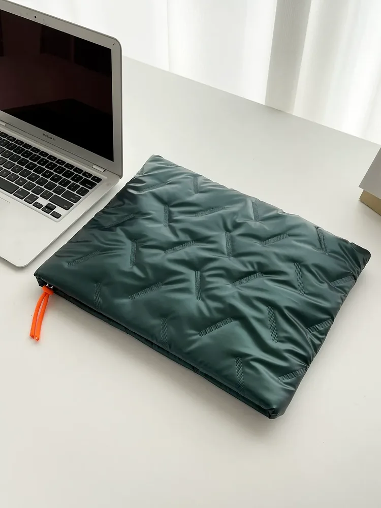 Waterproof laptop sleeve showing embossed texture and orange zipper pull