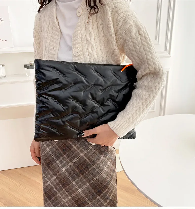 Embossed waterproof sleeve styled with a laptop on a bright desk