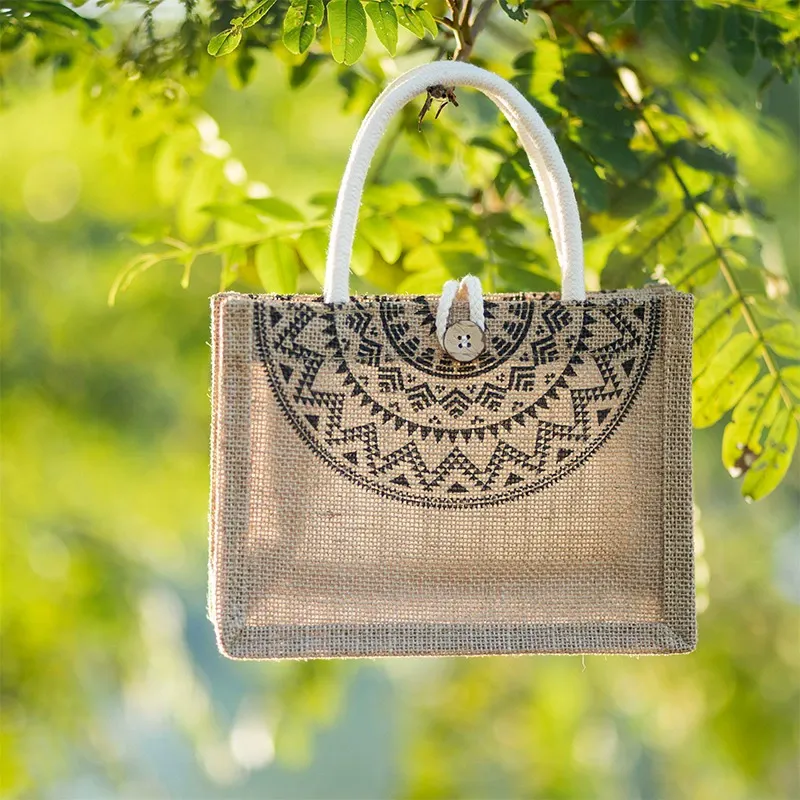 Wooden toggle closure and cotton rope handle detail on jute bag