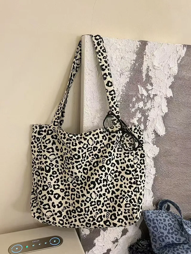 Leopard print canvas tote being carried as a fashion statement