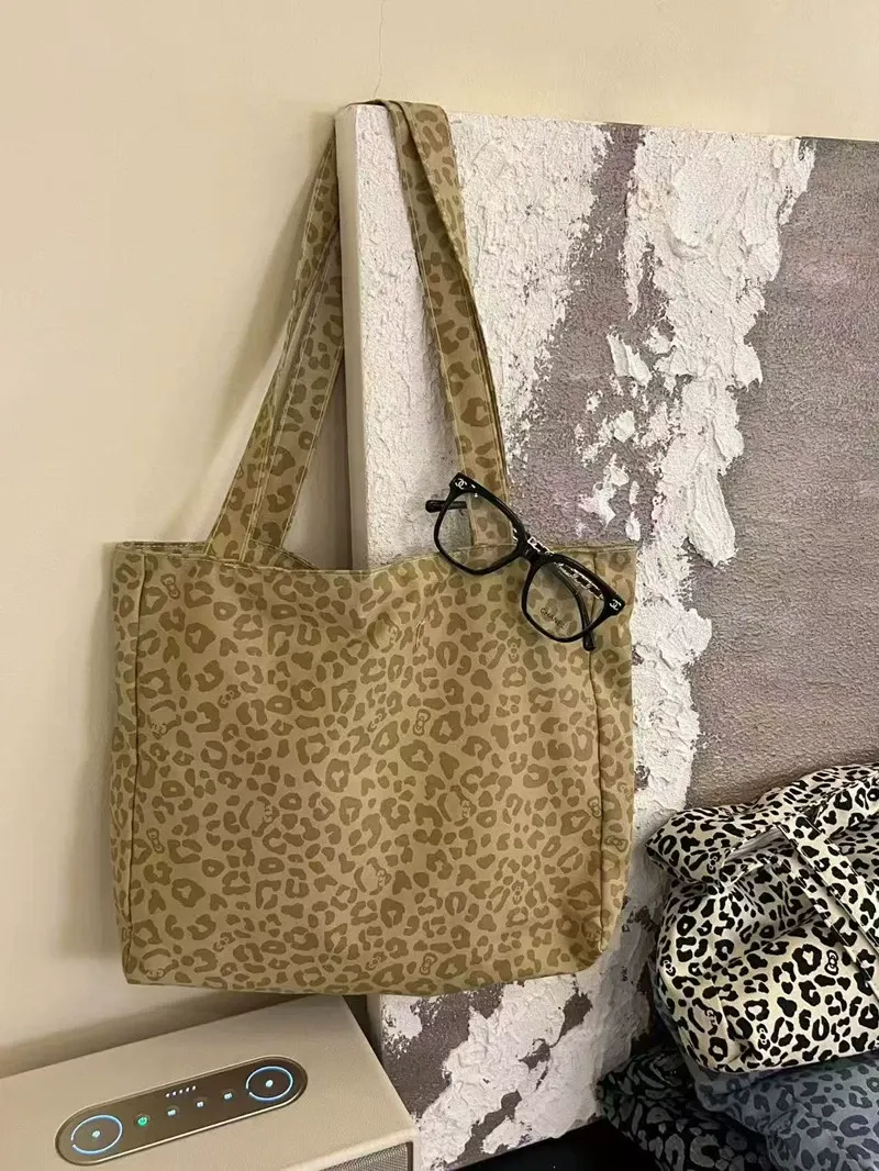 Model styled with leopard print tote, casual chic outfit