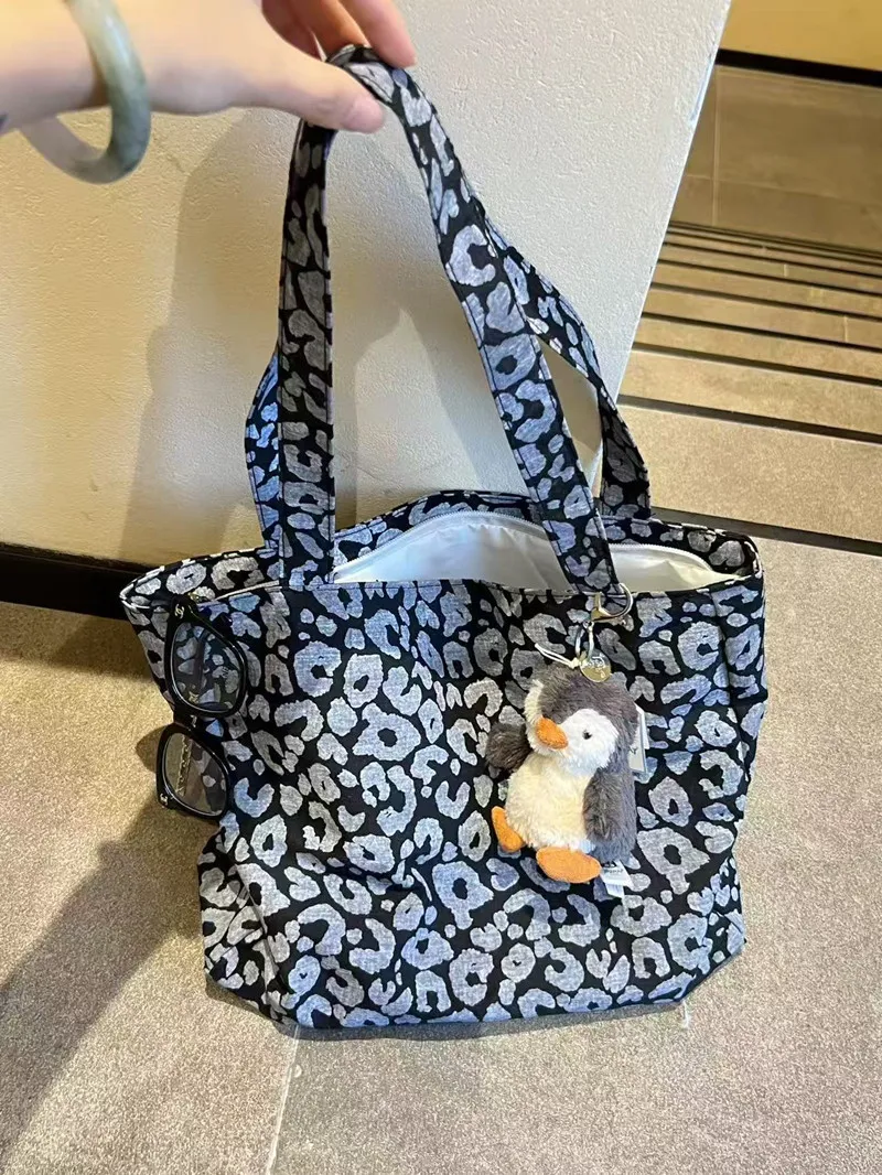 Classic tan leopard print canvas tote bag with zip closure
