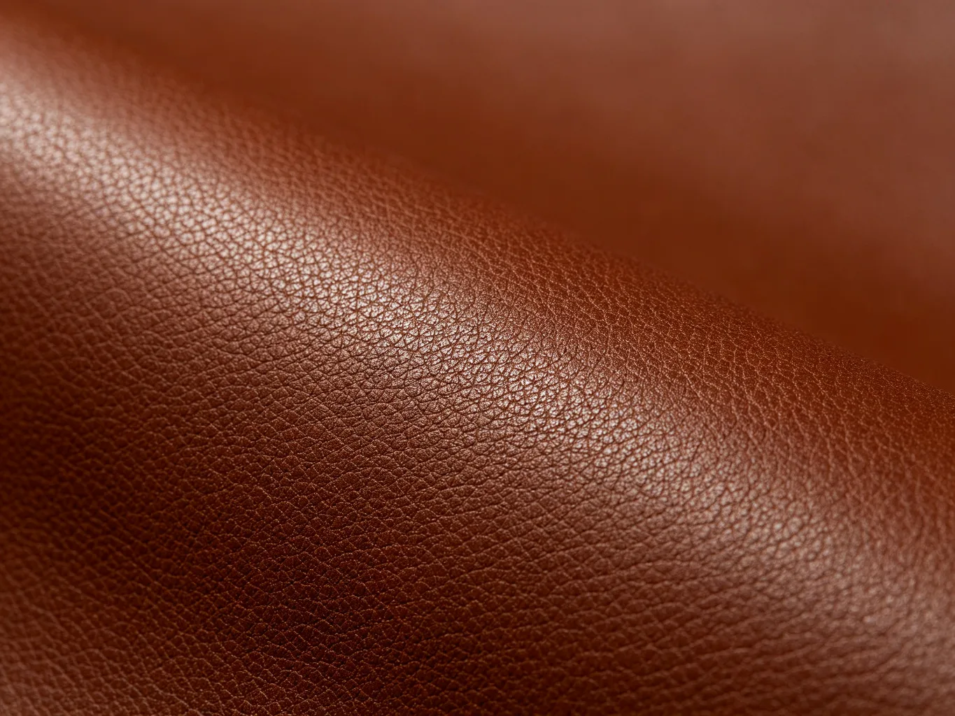 Vegan PU leather texture close-up, deep brown pebble grain