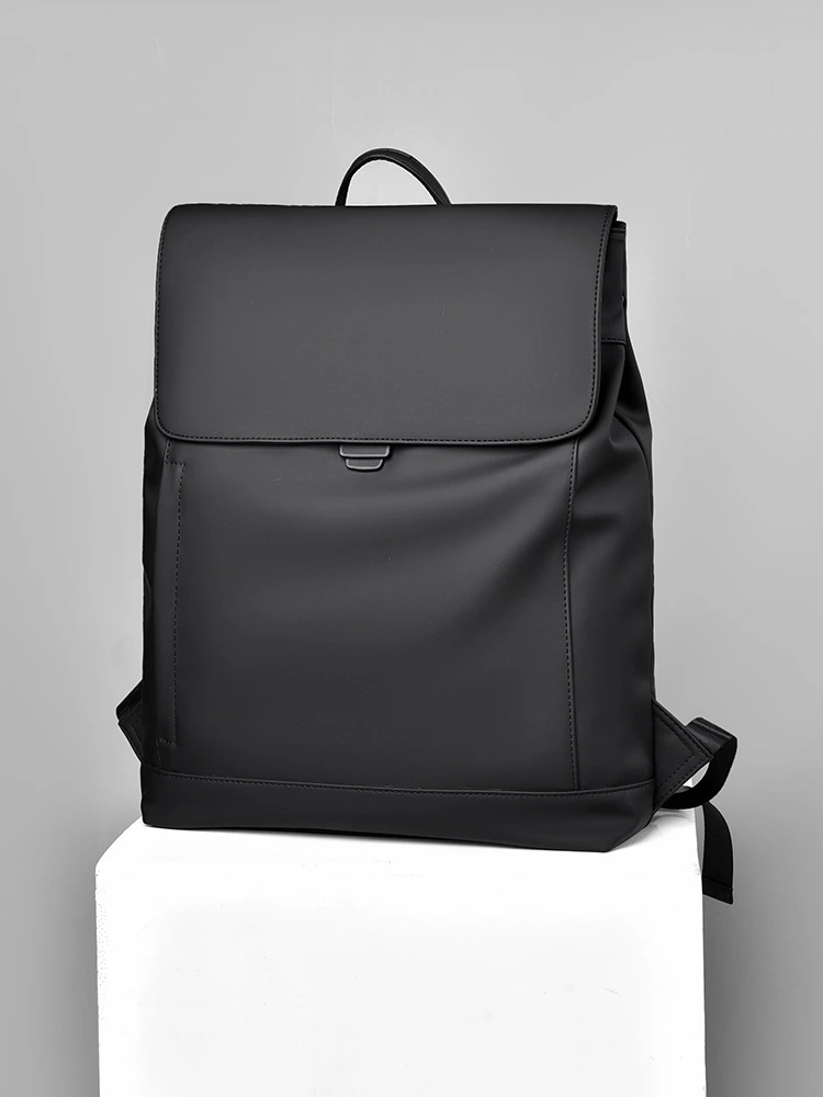 Black matte PU backpack manufacturing detail.
