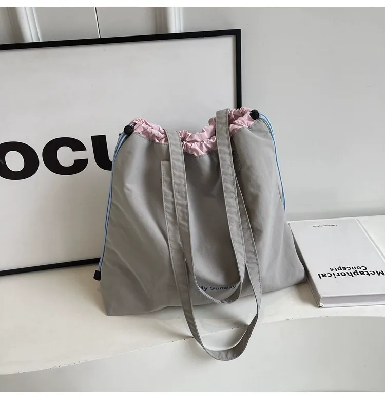 Nylon student tote being used on campus with books and laptop